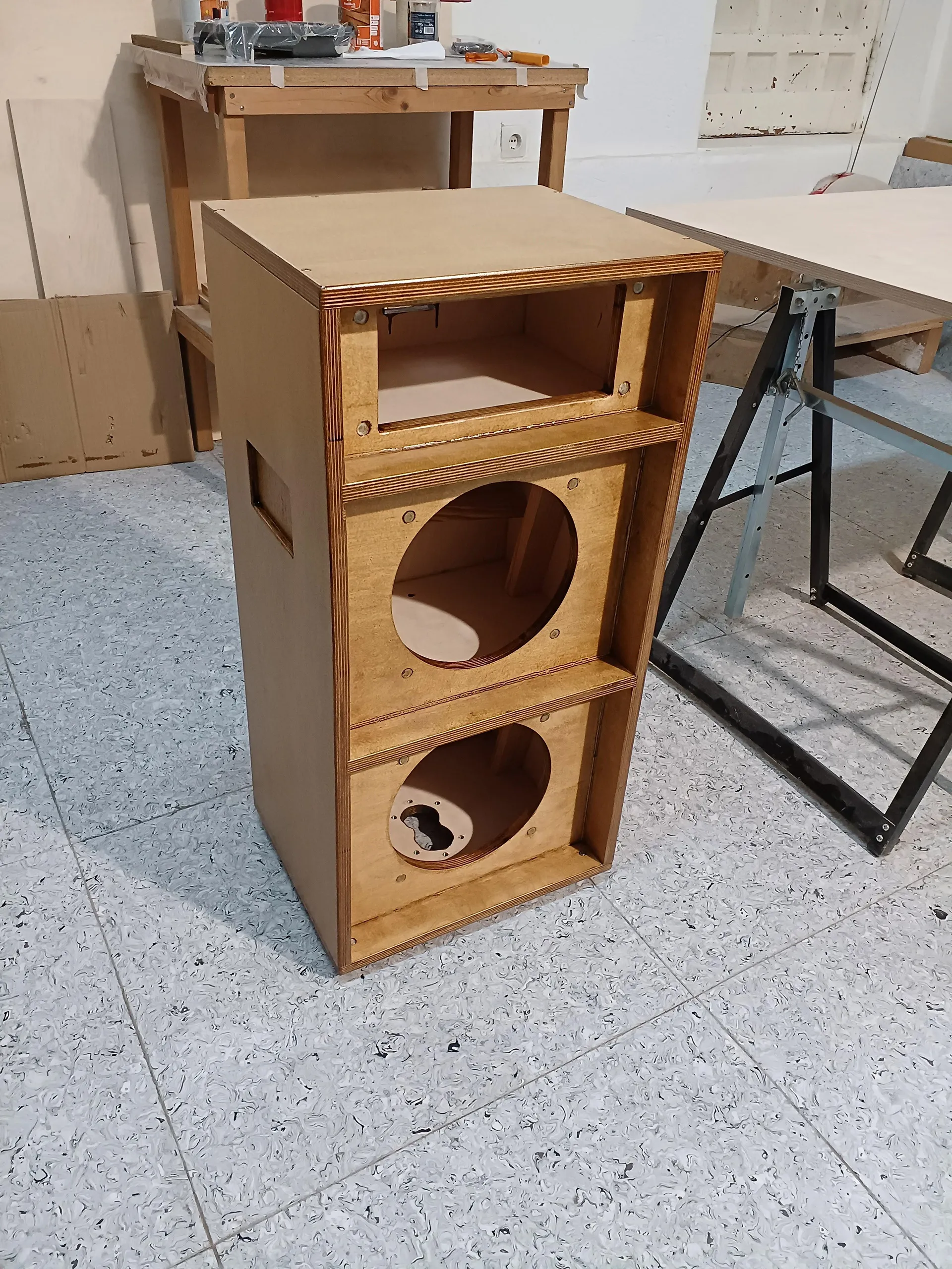 A cabinet varnished, before its speakers are mounted