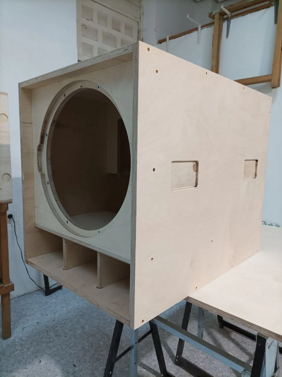 A subwoofer's bare plywood box